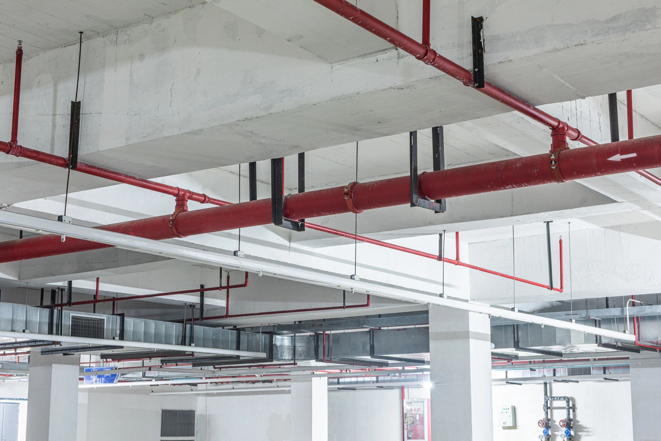 Red fire sprinkler pipes mounted on a ceiling