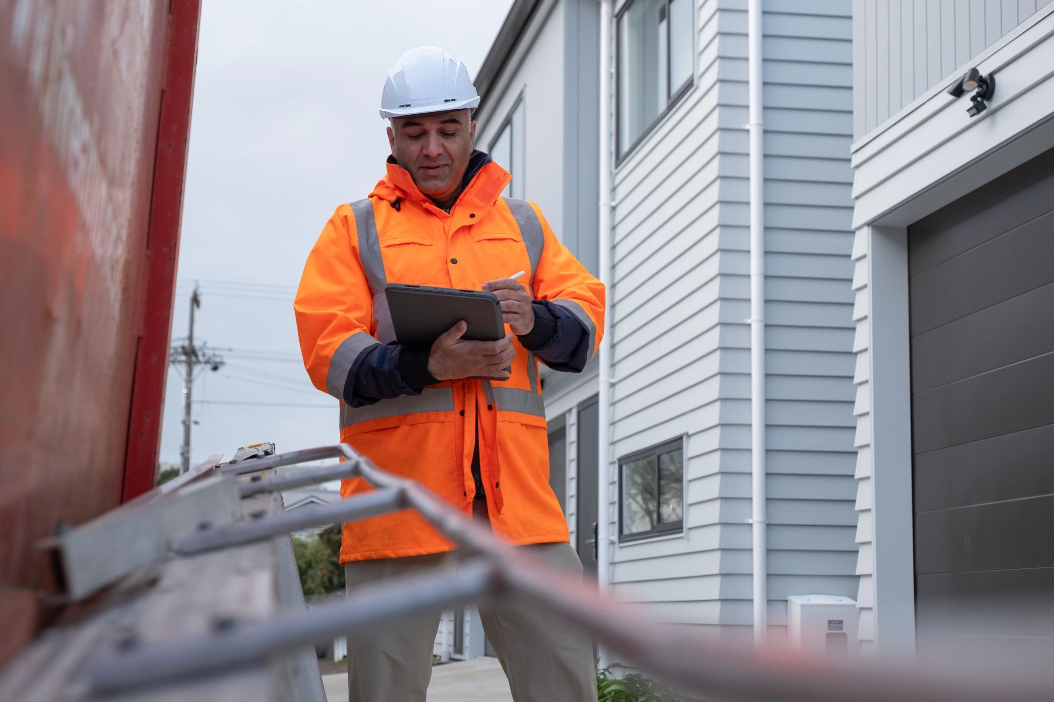 Site manager reviewing inspection notes on a tablet