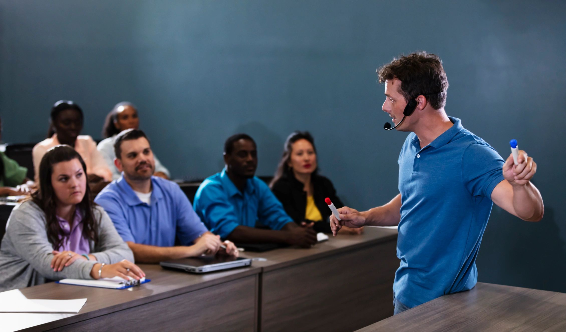 Trainer delivering a safety briefing to a group in a classroom setting