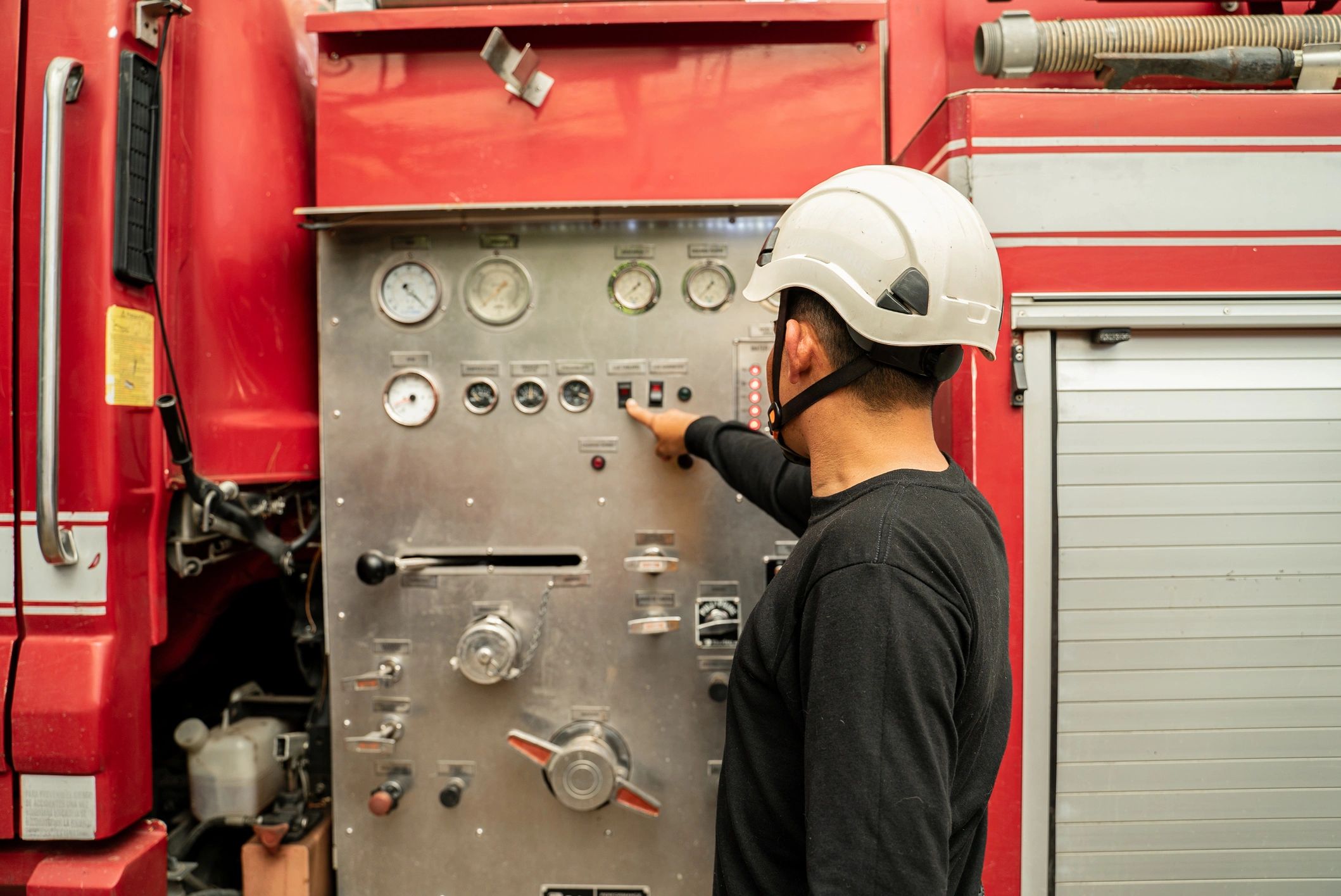 Firefighter interacting with equipment controls
